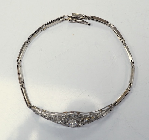 An early 20th century pierced gold, platinum and diamond set bracelet, the central motif set with round, eight and rose cut stones, 18cm, gross weight 8.9 grams. Condition - fair to good